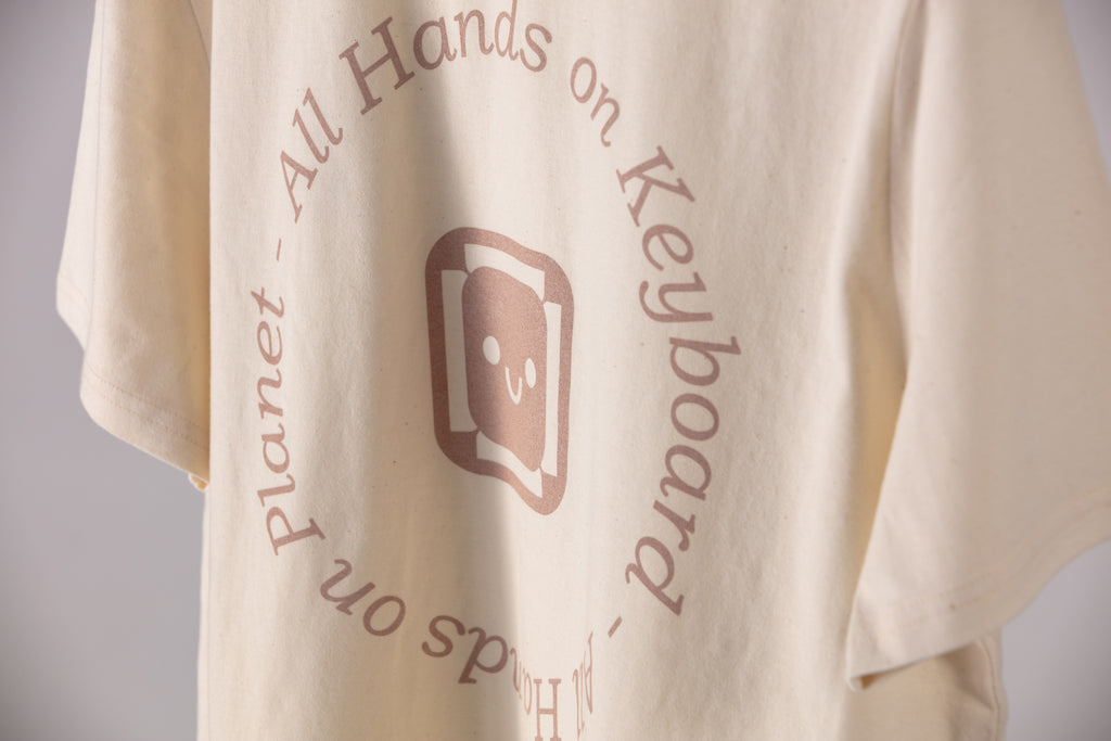 The Signature Tee. Natural. All Hands On Keyboard - All Hands on Planet Pink