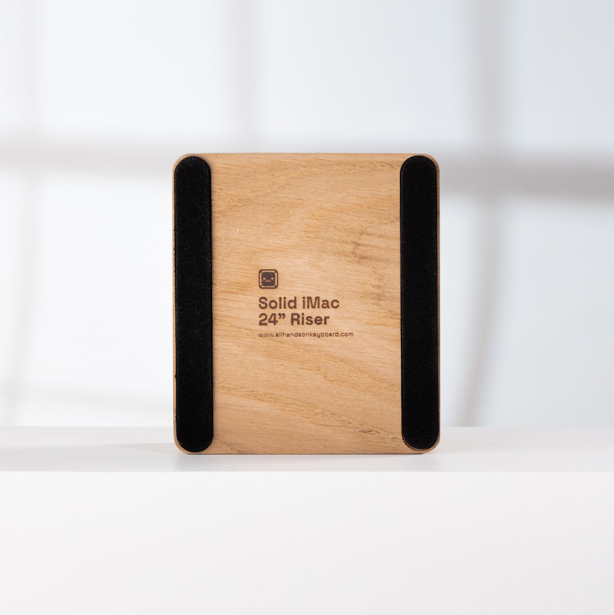 Bottom of Solid 24” iMac Riser - Oak on a white surface